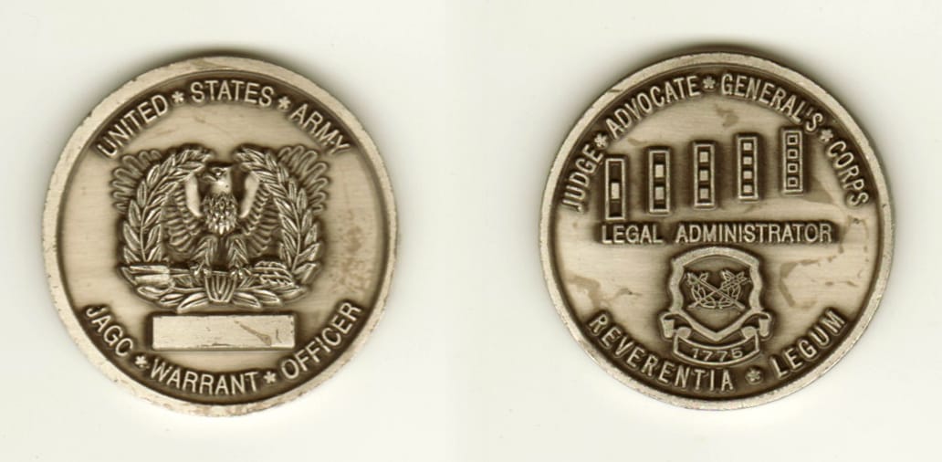 Round shaped, pewter colored coin, 1 3/4 inches in diameter.