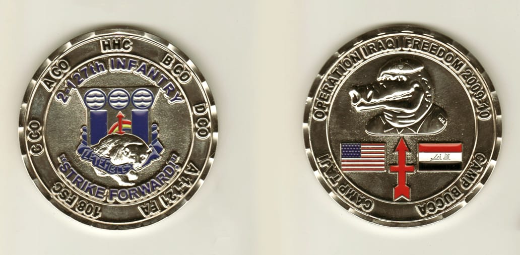 Round shaped, silver colored coin, 2 1/2 inches in diameter.