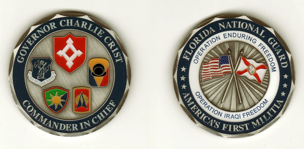 Round shaped, pewter colored coin, 2 inches in diameter.