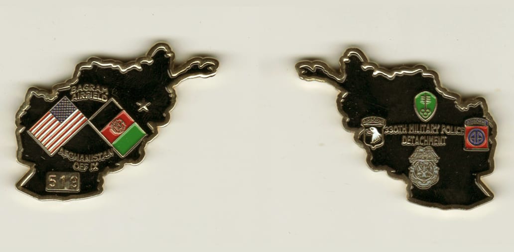 Afghanistan shaped, gold colored coin 2-3/8 inches iwide x 1-5/8 inches high.