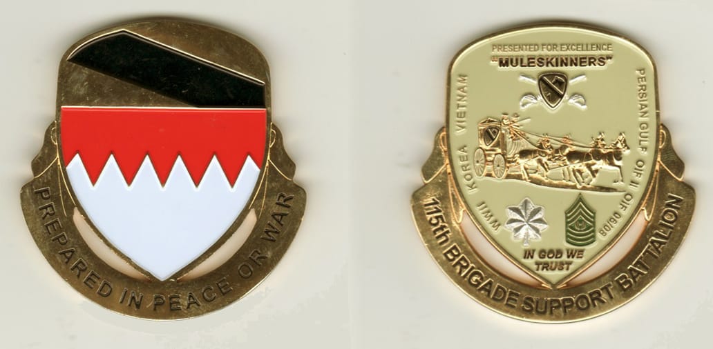 Rounded off-shield shaped, gold colored coin, with attached banner beneath, 2-1/4 inches wide x 2-1/4 inches high.