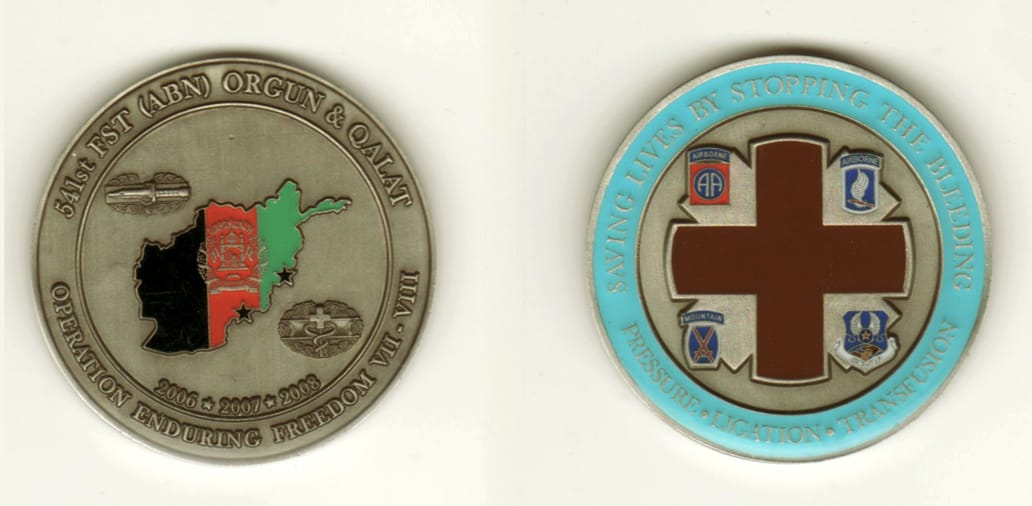 Round shaped, pewter colored coin, 2 inches in diameter.