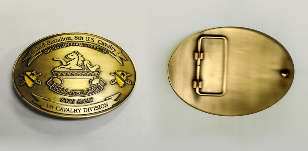 Oval shaped, brass colored belt buckle, 3-13/16 inches wide  by 2-3/4 inches high.