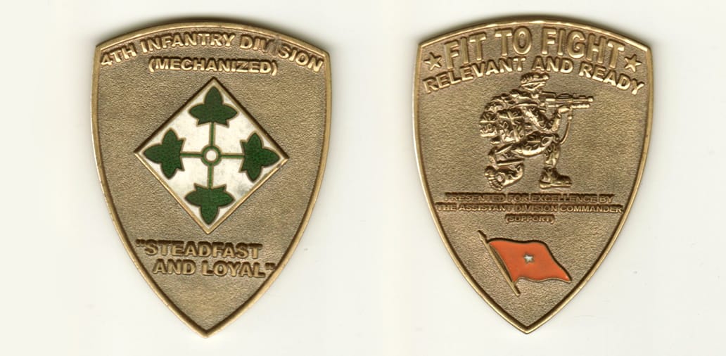 Shield shaped, antique brass colored coin with rounded top and pointed bottom, 2 inches wide x 2-1/2 inches high.