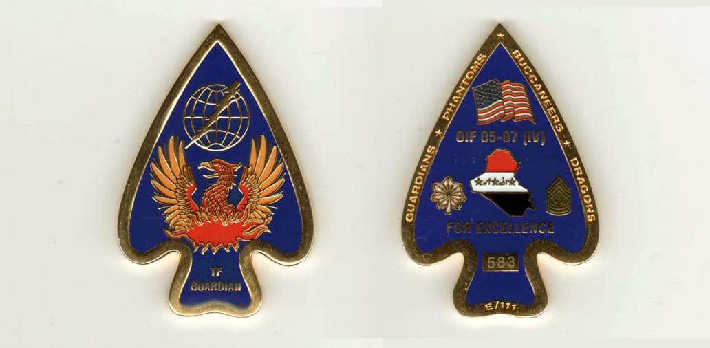 Arrowhead shaped, gold colored coin, 1-1/2 inches wide x 2-1/2 inches high.