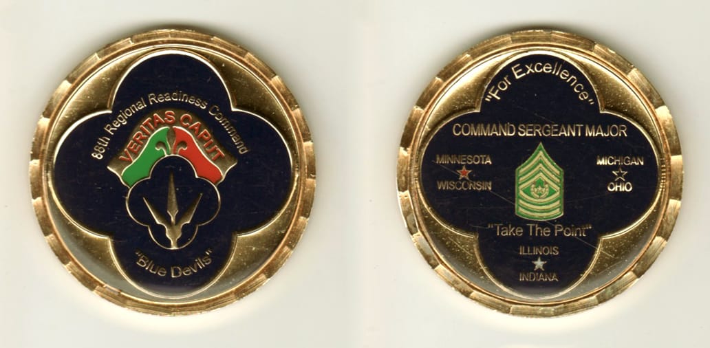 Round shaped, gold colored coin, 2 inches in diameter.