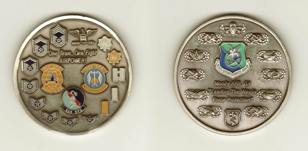 Round shaped, silver colored coin, 2 inches in diameter.