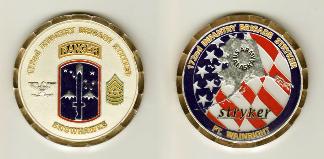 Round shaped, brass colored coin, 2 inches in diameter.