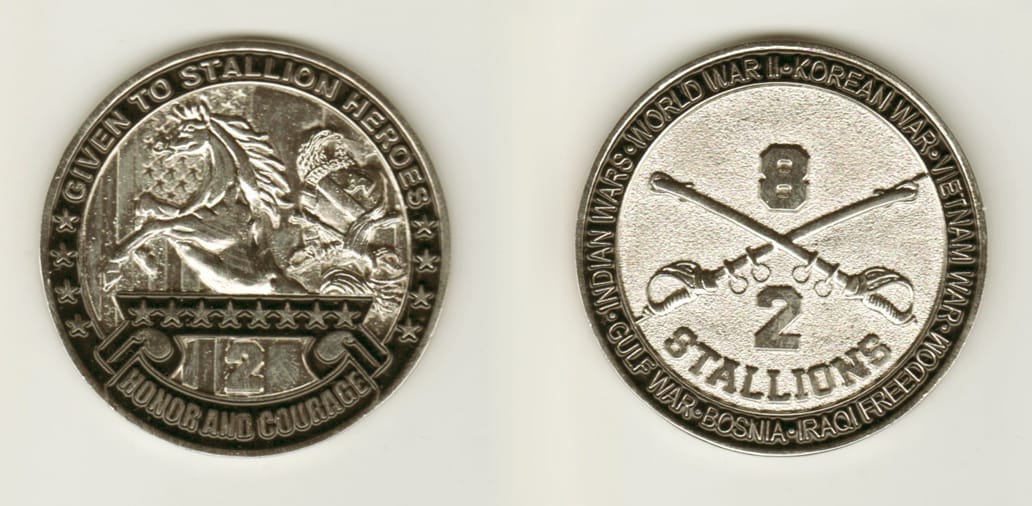 Round shaped, silver colored coin, 2 inches in diameter.