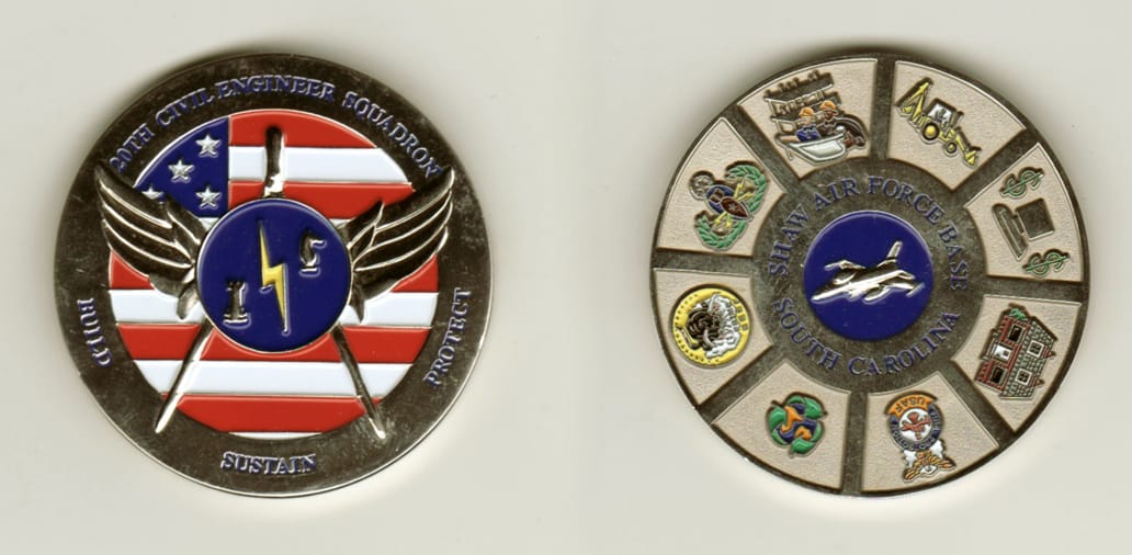 Round shaped, silver colored coin, 2 inches in diameter.