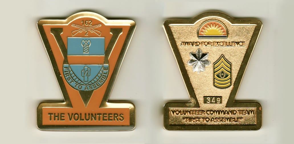 V shaped, gold colored coin, with bar mounted across bottom , 2-1/2 inches high x 2-1/8 inches wide