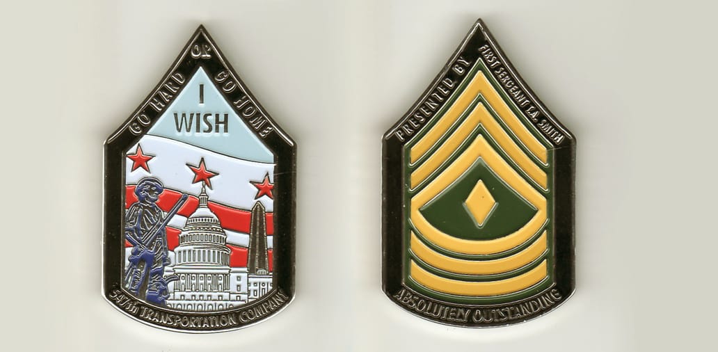 First Sgt Chevron shaped with, brass colored coin, 1-3/4 inches wide x 2-1/4 inches high.