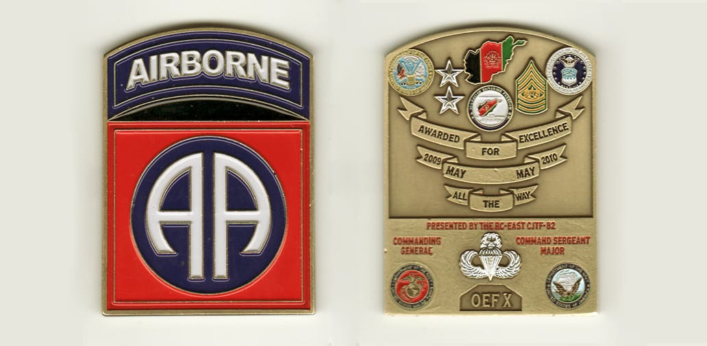 Retangular shaped with bowed top, brass colored coin, 1-3/4 inches wide x 2-1/2 inches high.