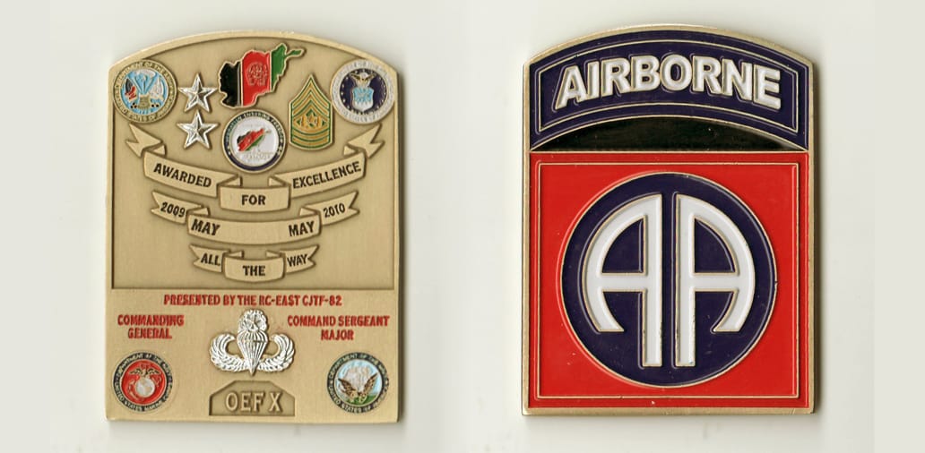 Retangular shaped with bowed top, brass colored coin, 1-3/4 inches wide x 2-1/2 inches high.