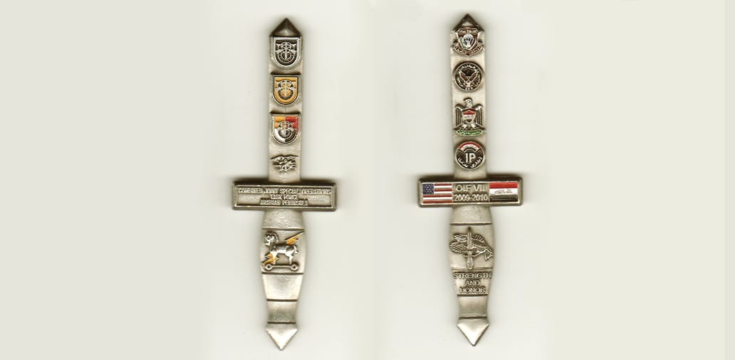 Sword shaped with, silvercolored coin, 1-3/4 inches wide x 2-1/2 inches high.