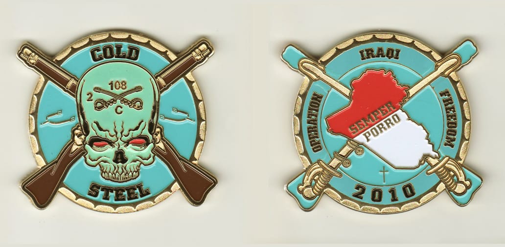 Round shaped, with crossed rifles extended, brass colored coin, 2-1/4 inches in diameter.