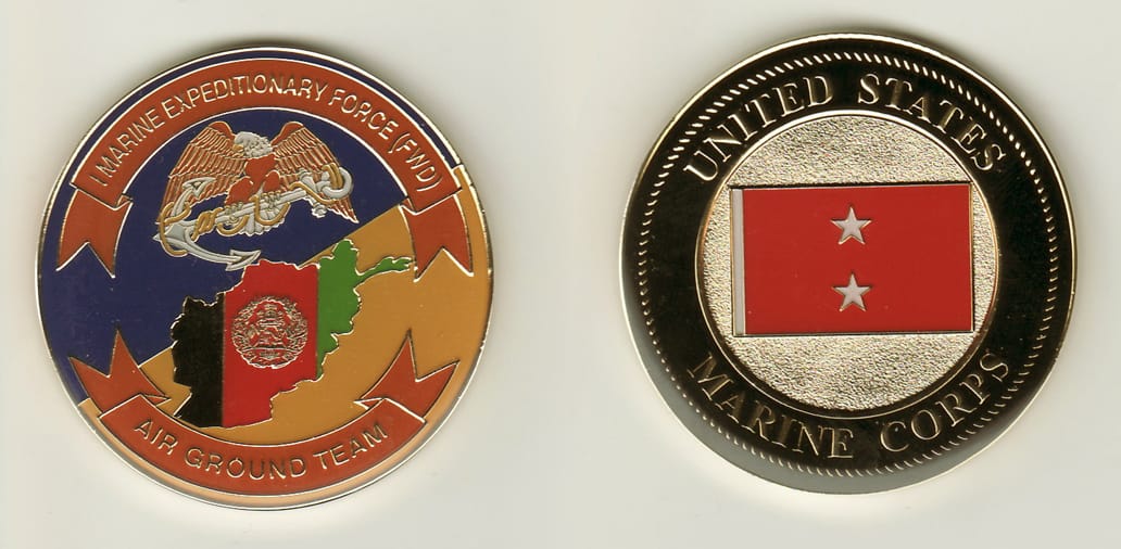 Round shaped, gold colored coin, 2 inches in diameter.