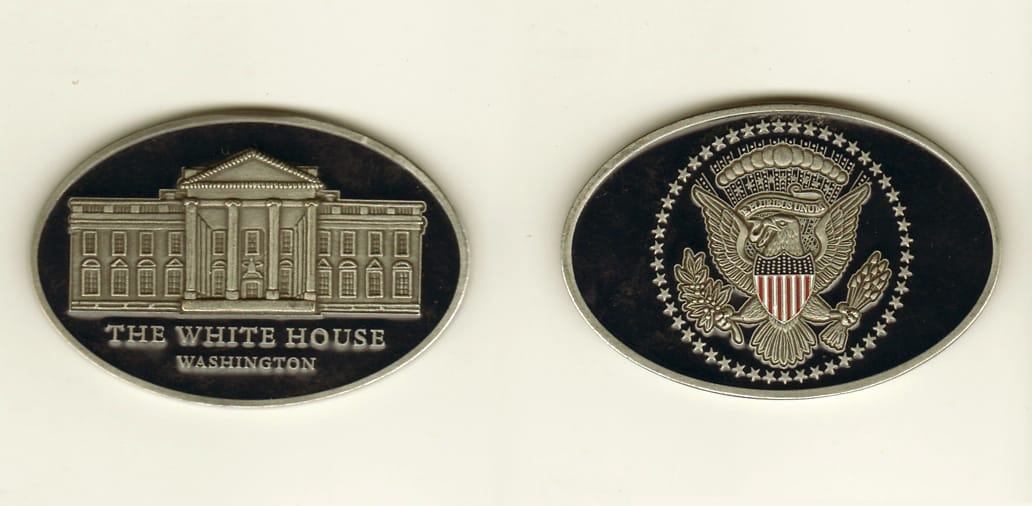 Oval shaped, pewter colored coin, 1-3/4 inches high x 2-9/16 inches wide