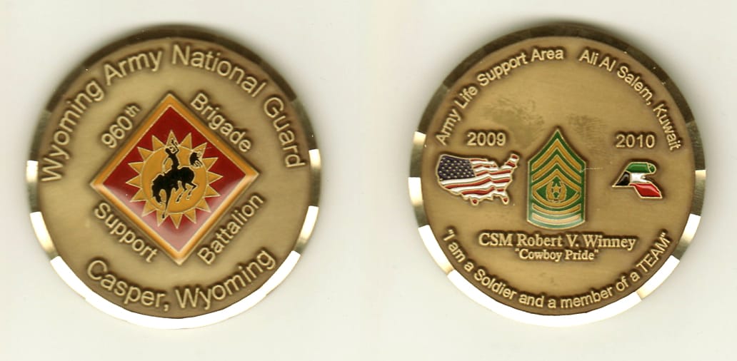 Round shaped, brass colored coin, 1-7/8 inches in diameter.