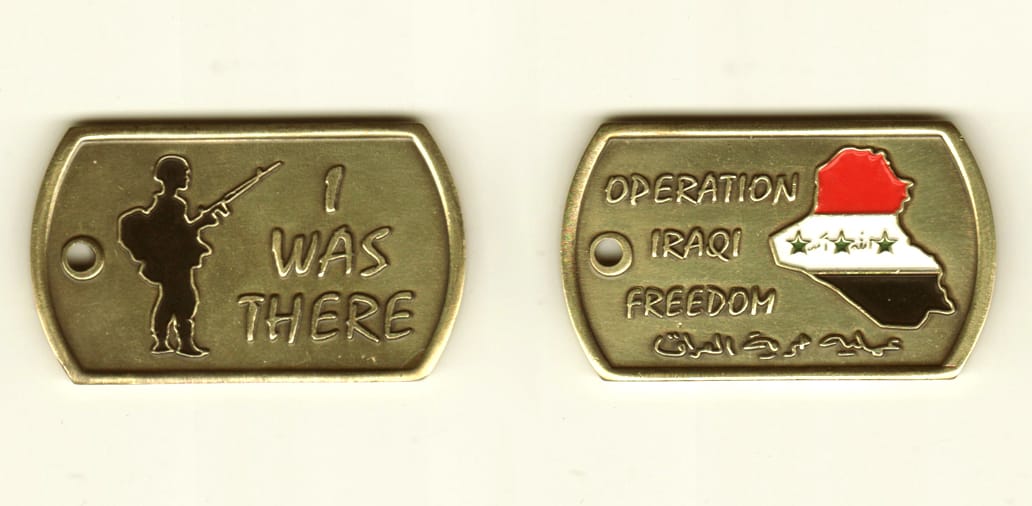 Dog tag shaped, brasscolored coin, 2 -1/4 inches wide x 1-1/2 inches high.