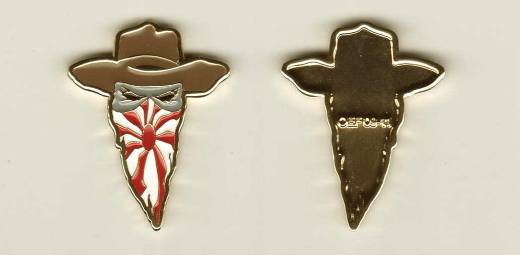 Masked bandit with cowboy hat shaped, gold colored coin, 1-1/4 inches wide x 1-1/2 inches high.