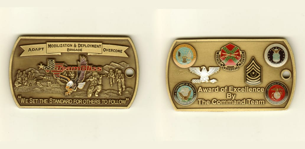 Dog tag shaped, brass colored coin, 2 3/4 inches wide x 1-1/2 inches high.