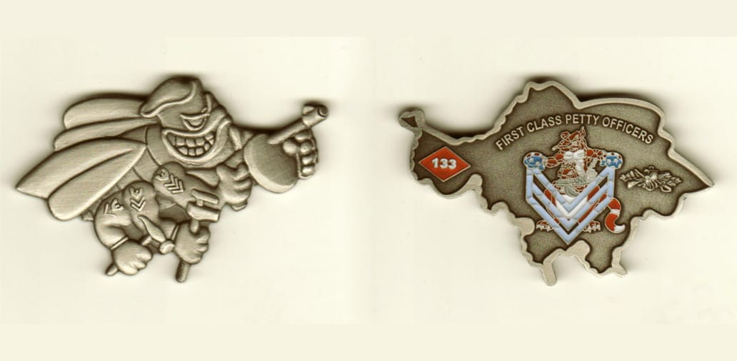 Seabee shaped, pewter colored coin, 2 inches wide x 1-1/4 inches high.