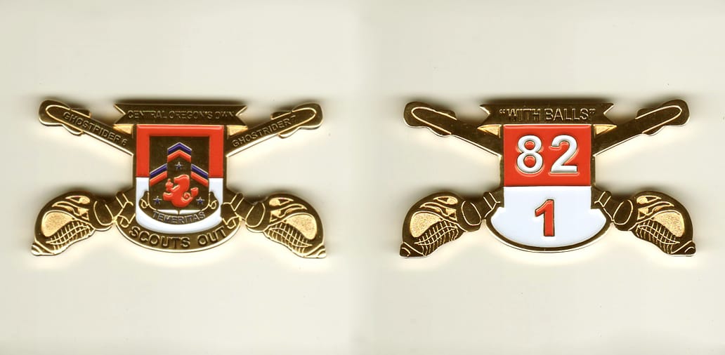 Shield shaped, with crossed sabers extended, gold colored coin, 2-1/4 inches wide x 1-1/8 inches high.