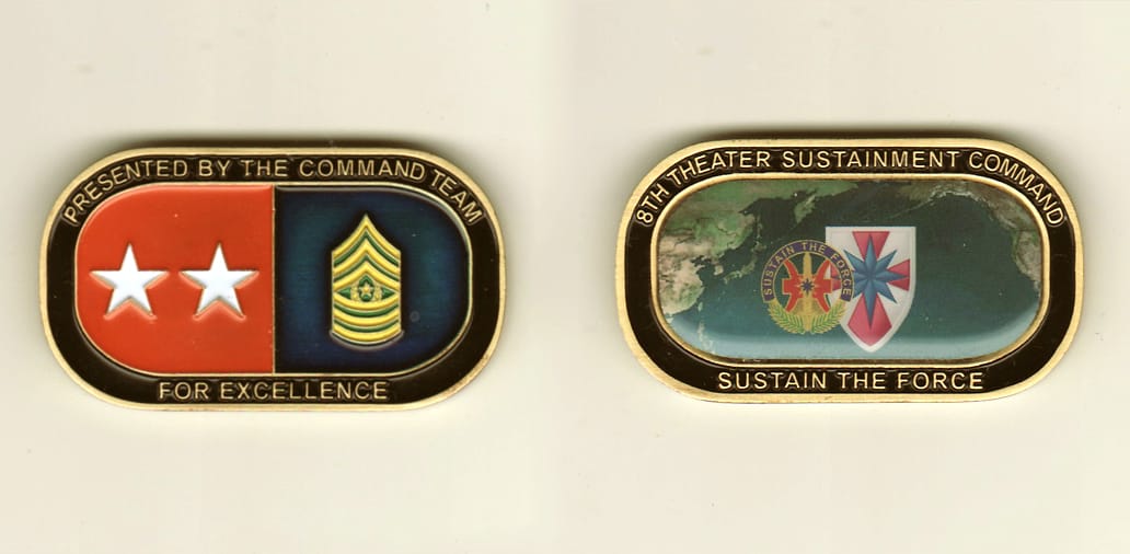 Dog tag shaped, brass colored coin, 2 inches wide x 1-1/4 inches high.