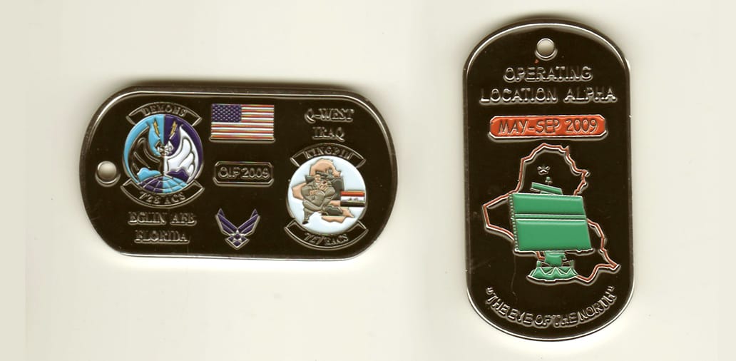 Dog tag shaped, silver colored coin, 2-1/4 inches wide x 1-1/4 inches high.