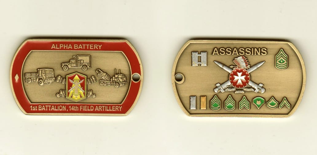 Dog tag shaped, brass colored coin, 2-1/4 inches wide x 1-1/4 inches high.