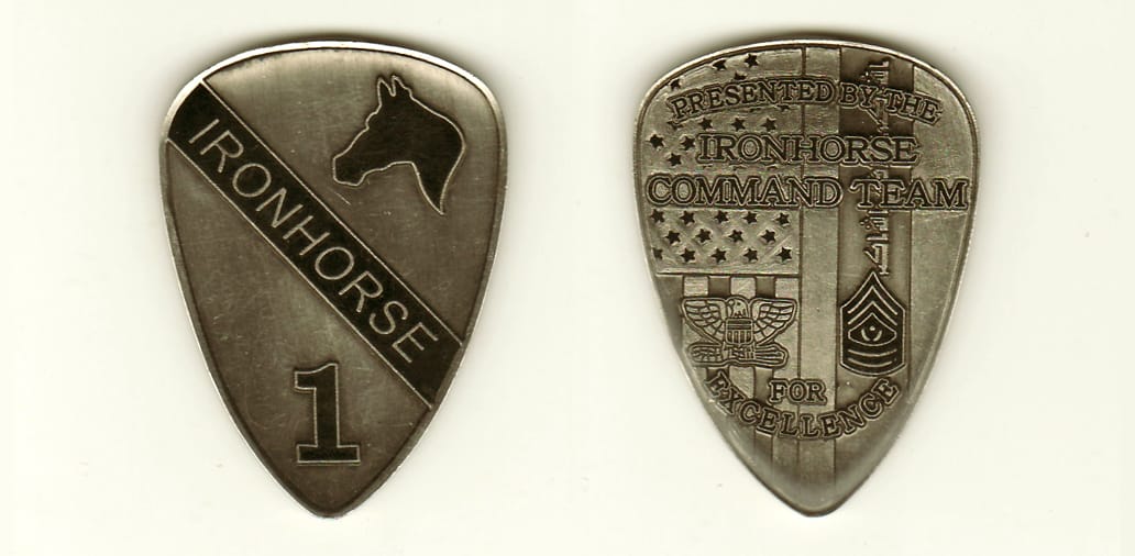 Shield shaped, pewter colored coin,1-1/2 inches wide x 2 inches high.