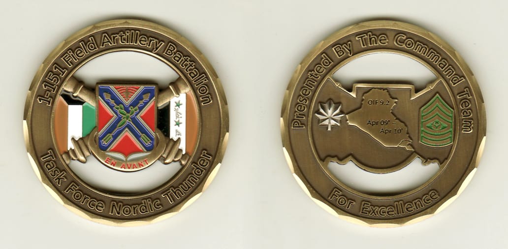 Round shaped with cut out area, brass colored coin, 2 inches in diameter.