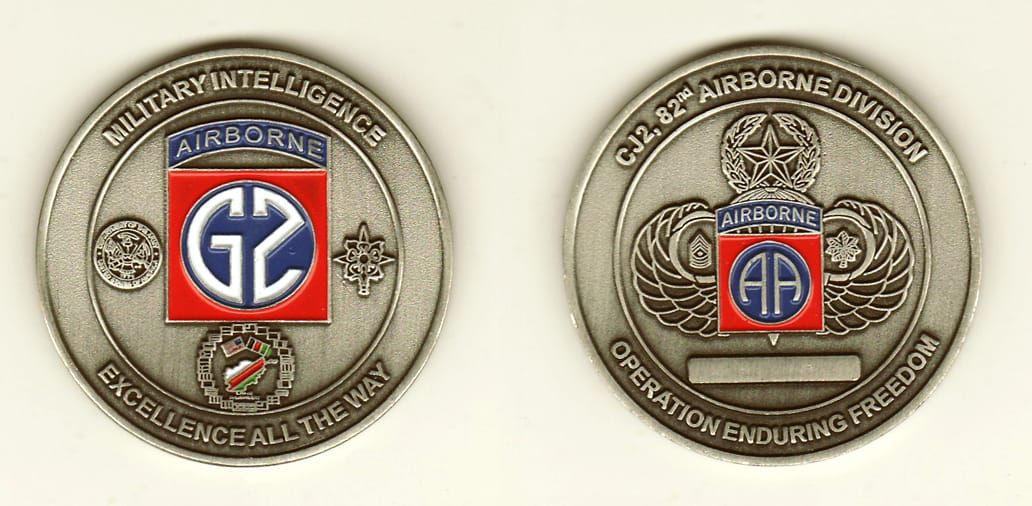 Round shaped, pewter colored coin, 2 inches in diameter.