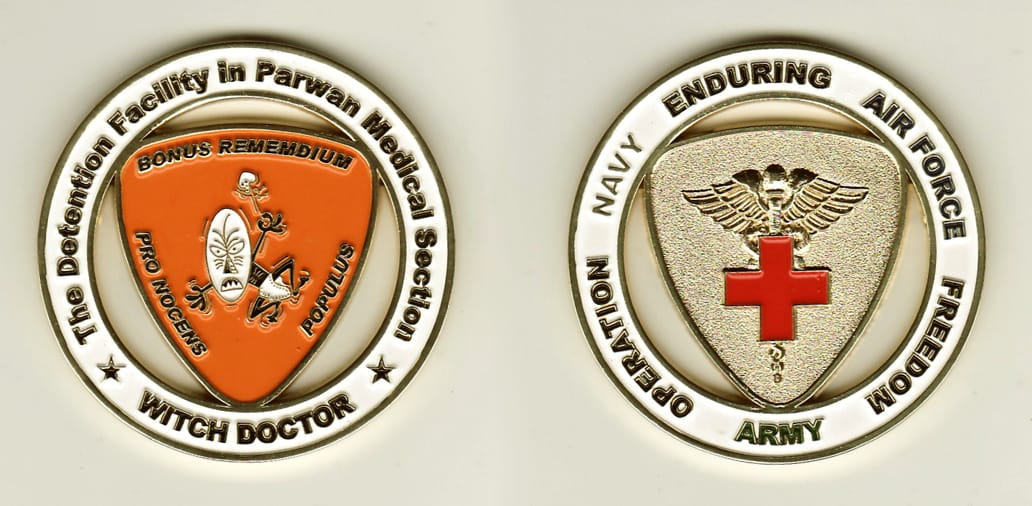 Round shaped, gold colored coin, 2 inches in diameter.