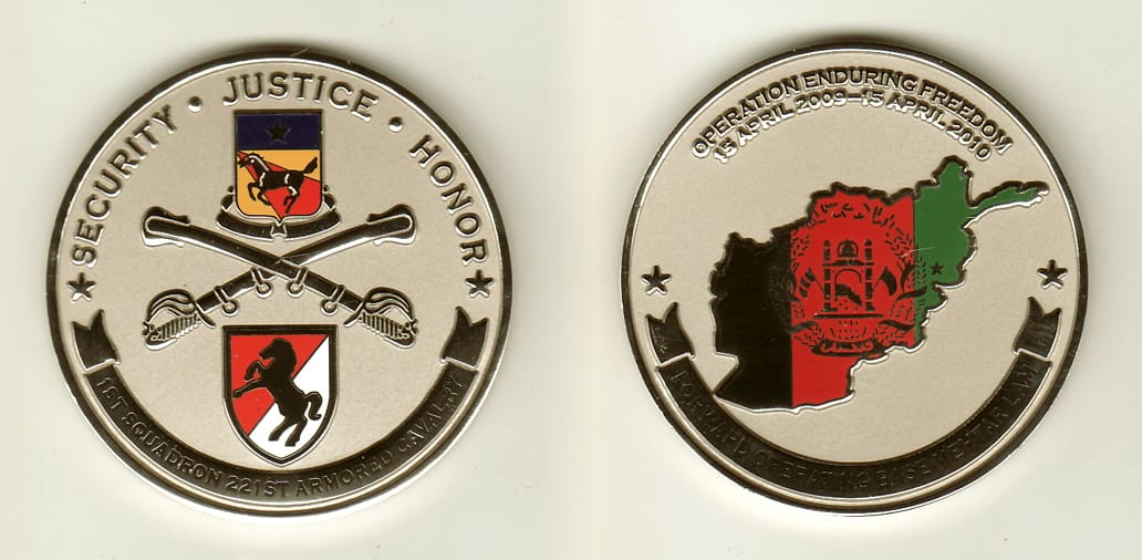 Round shaped, silver colored coin, 2 inches in diameter.