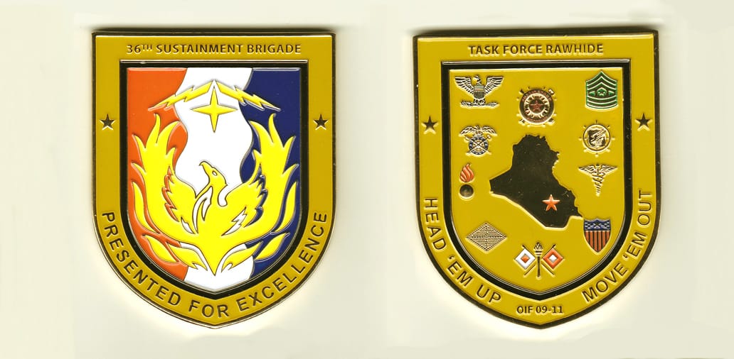 Shield shaped, gold colored coin, 2-1/2 inches wide x 3 inches high.