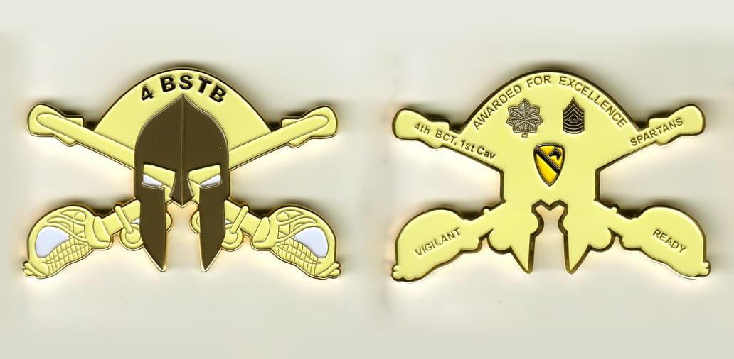 Cross saber shaped with Spartan helmet and half circle extending, gold colored coin, 3 inches wide x 2 inches high.