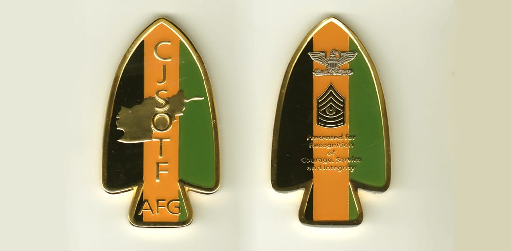 Arrowhead shaped, gold colored coin, 1-1/2 inches wide x 2-3/4 inches high.