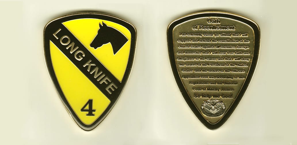 Shield shaped, gold colored coin, 2-3/8 inches wide x 3 inches high.