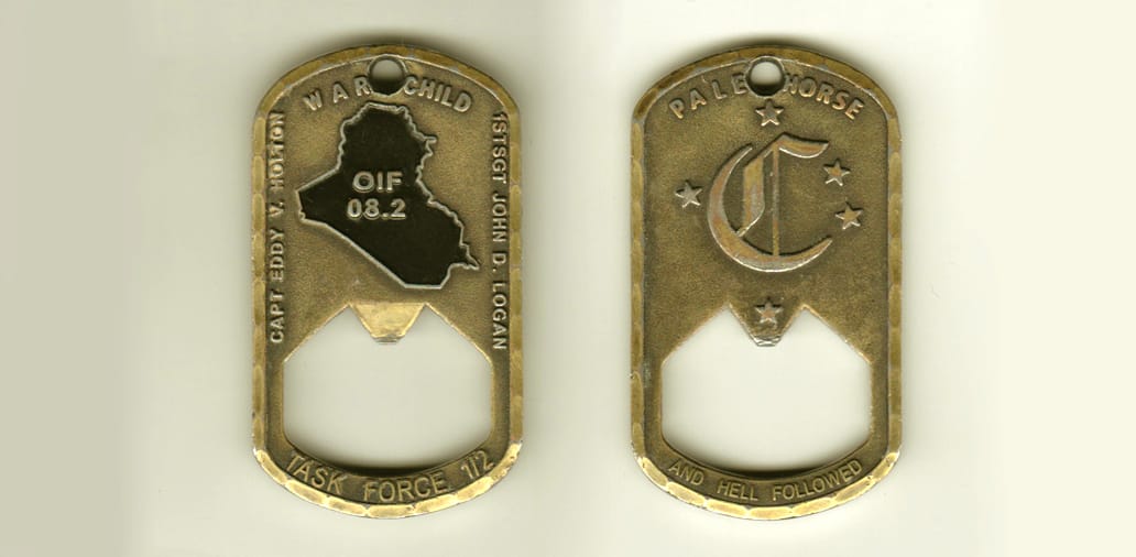 Dog tag shaped, antique brass colored coin, 1-3/8 inches wide x 2-1/2 inches high.