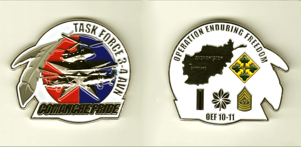 Circular shaped, with banner mounted and extending near base, and bird feathers extended from the side, silver colored c...