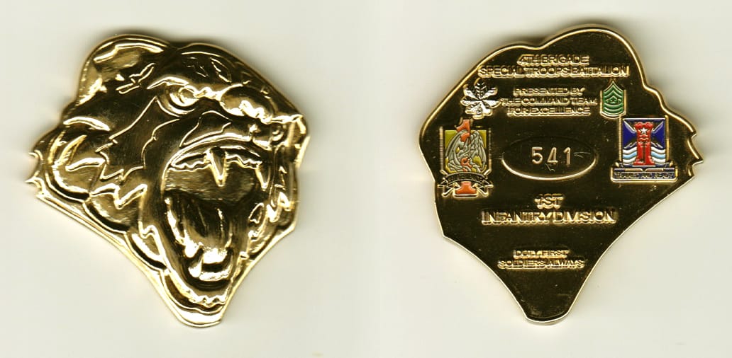 Panther head shaped, gold colored coin, 1-1/2 inches wide x 2 inches high.