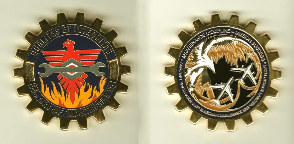 Cog shaped, gold colored coin, 2 inches in diameter.