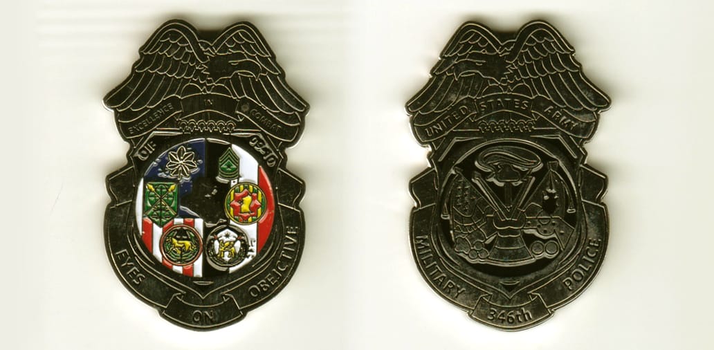 MP Badge shaped with banner mounted beneath and eagle mounted above, silver colored coin,1-3/8 inches wide x 2 inches hi...