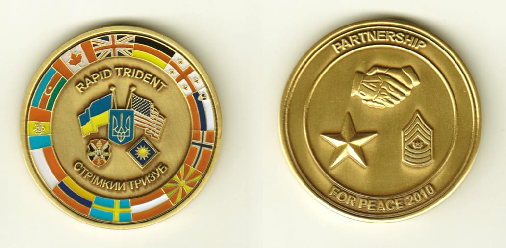 Round shaped, brass colored coin, 1-3/4 inches in diameter.