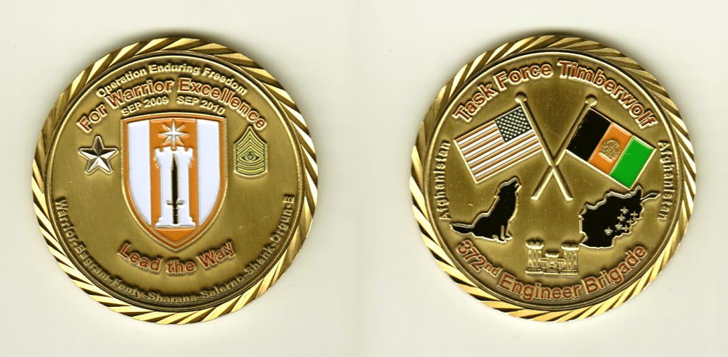 Round shaped, brass colored coin, 2 inches in diameter.