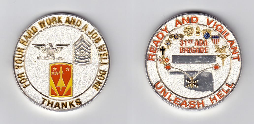 Round shaped, silver colored coin, 2 inches in diameter.