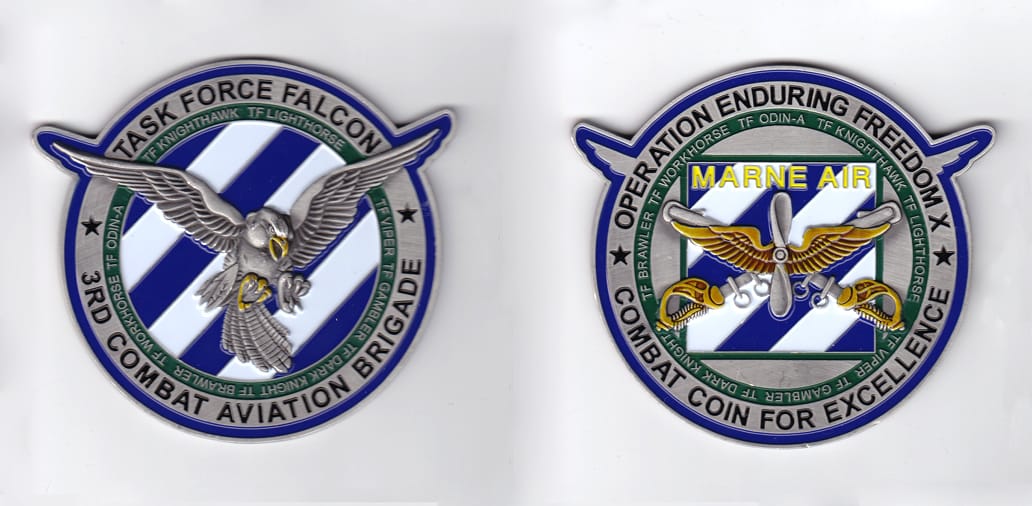 Round shaped, with tips of eagle's wings extending, pewter colored coin, 3-1/2 inches in diameter.