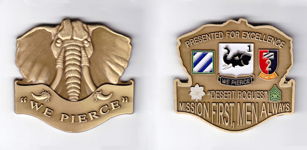 Elephant head shaped with banner mounted beneath, brass colored coin, 2-3/4 inches wide x 2-1/2 inches high.